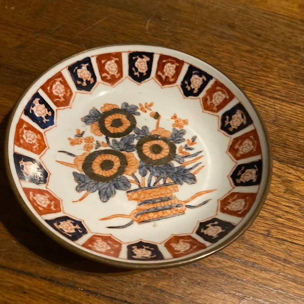 Vintage brass encased Imari porcelain plate.